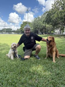 Rover dog training Miami alternative: trainer working with two dogs at a South Miami park